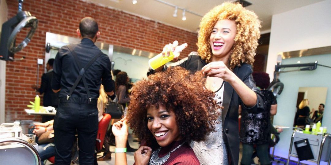 Salon styling session with a client wearing voluminous natural curls